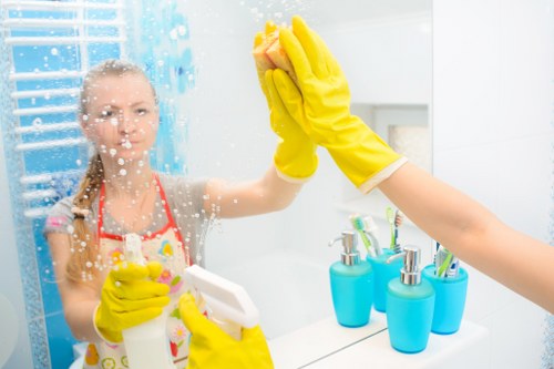 A cleaner tidying a Hampstead kitchen during routine cleaning