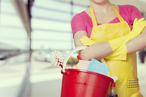Cleaning kitchen cupboards and surfaces during a move in clean in Hampstead